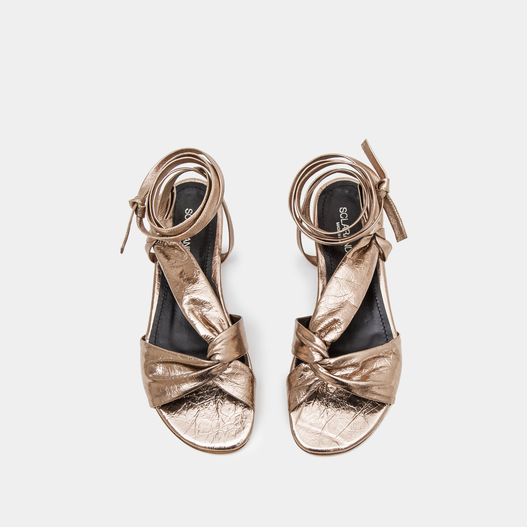 Bronze metallic Knotted nappa flat sandal with an ankle tie wrap